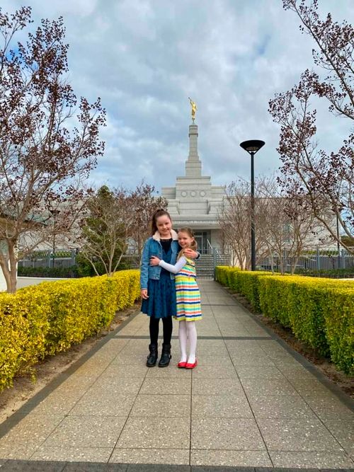 two girls standing outside of temple