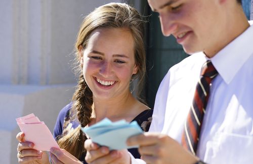 young man and young woman looking at temple name cards