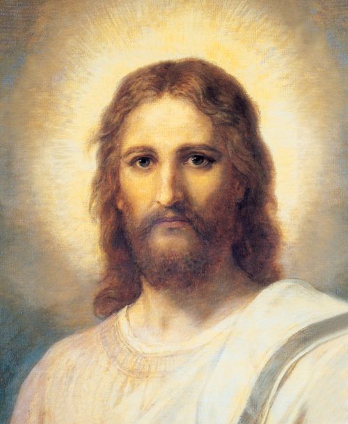 A portrait of Christ in white robes, with bright light around His head, looking out toward the viewer.