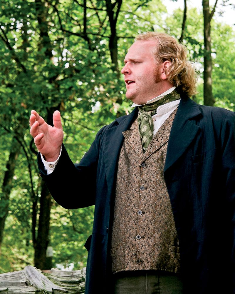 An actor in the Nauvoo Pageant standing and acting as a preacher.
