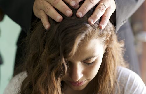 young woman with hands on her head
