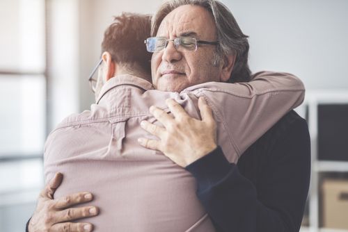son hugs his father
