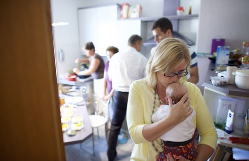 woman holding and kissing baby