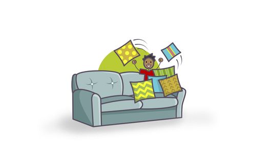 boy breaking through pillows on a couch