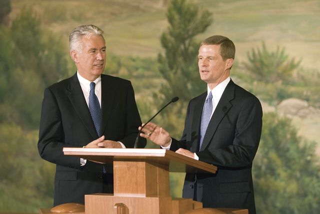Elder David A. Bednar and Elder Dieter F. Uchtdorf at a press conference following their calling as Apostles in October 2004.  Elder Bednar is speaking at the pulpit set up in front of the