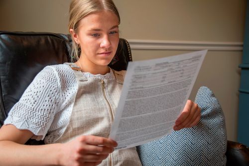 young woman reading patriarchal blessing