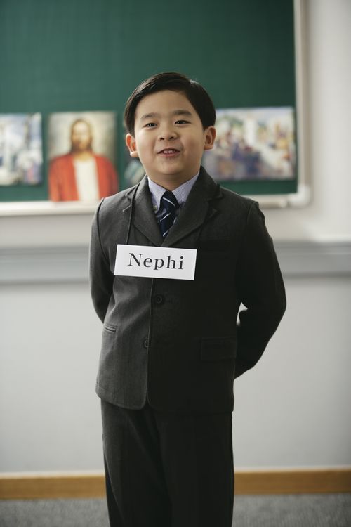 young boy wearing the name Nephi around his neck