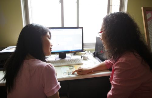 women sitting in front of computer