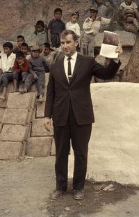 Richard G. Scott holding up Book of Mormon