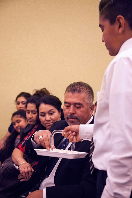 Members of a Spanish speaking Church branch in Hurricane, Utah receiving the sacrament during a sacrament meeting.