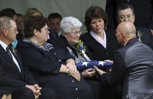 Sister Packer receiving a flag