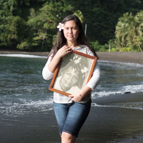 young woman with photograph of ancestor