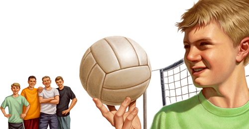 A young man holding a volleyball and standing next to a net.  A group of young men are standing together in the distance.