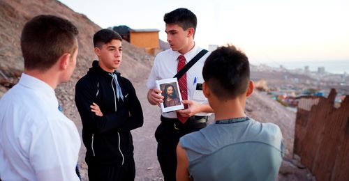 young man and missionaries