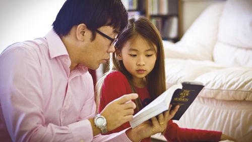 man and girl reading scriptures