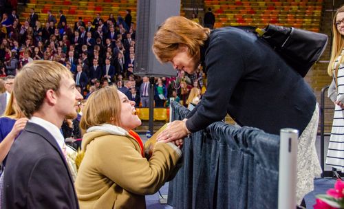 Sister Eubank shaking woman’s hand