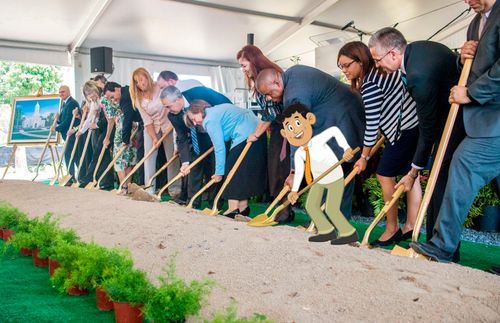 people digging at a temple groundbreaking