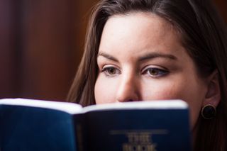 young woman reading the Book of Mormon