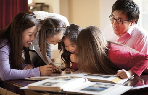 family looking at photo albums