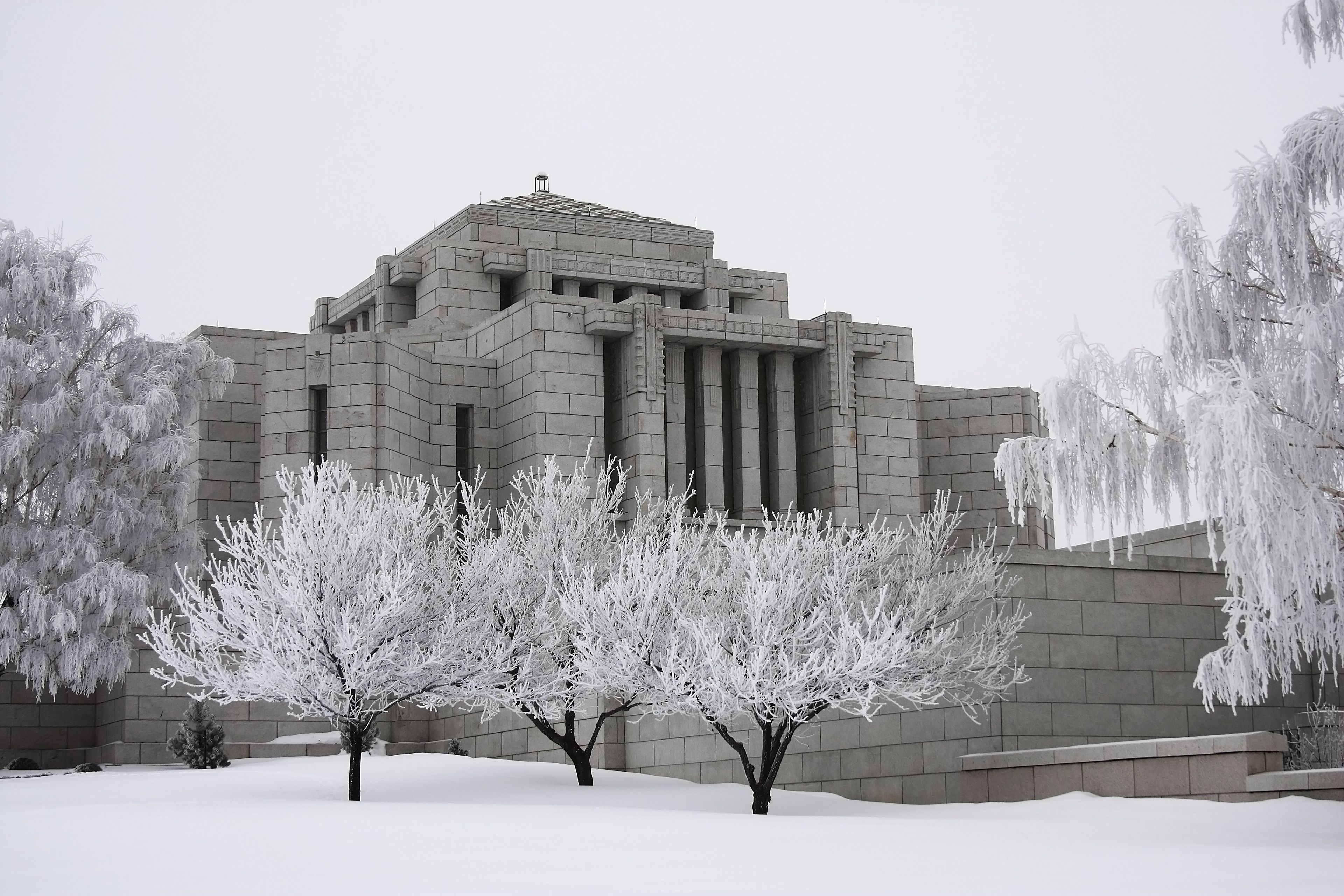 The Cardston Alberta Temple during winter, including the entrance and exterior of the temple.