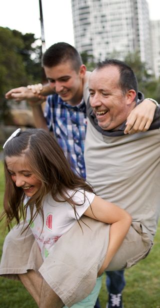 children carrying their father