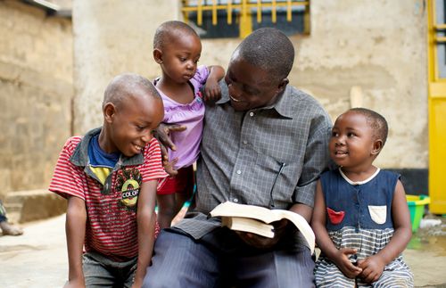 Father reading scriptures