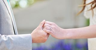 a bride and groom hold hands