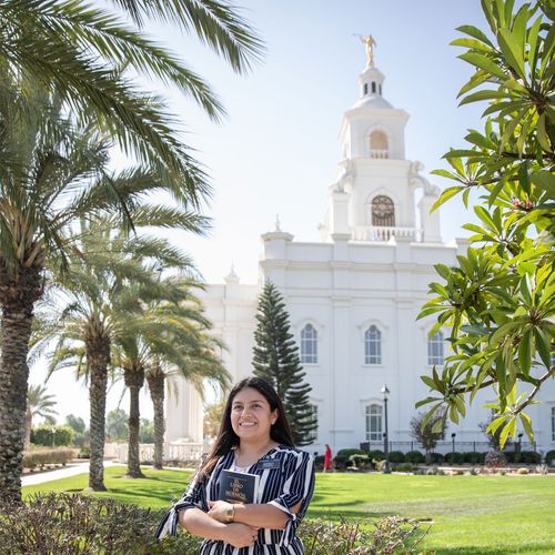 sister missionary standing in front of temple