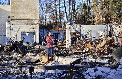 Rachel standing in burned down house