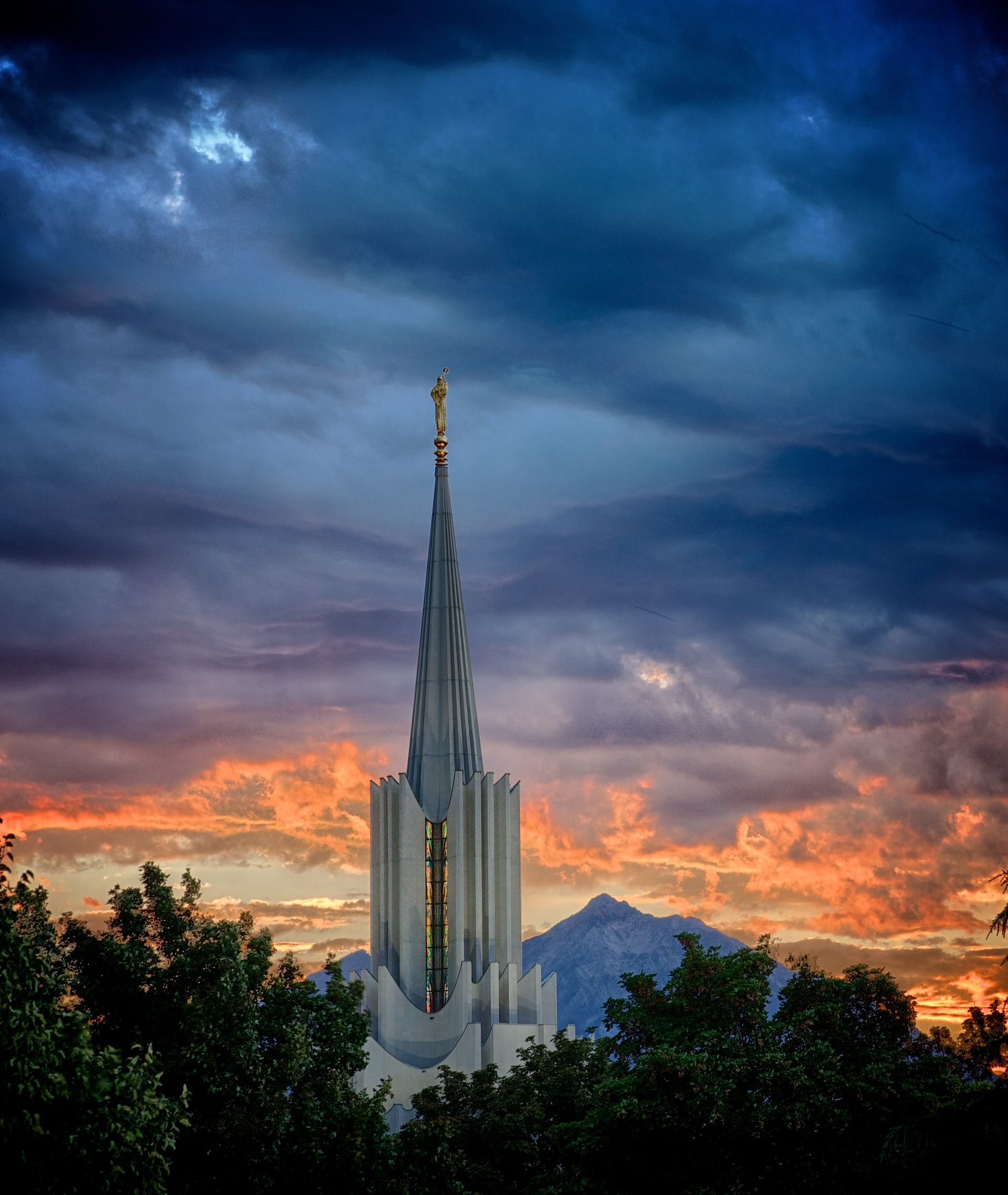 A view of the spire of the Jordan River Utah Temple at sunset.