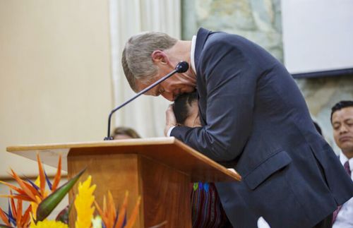 a girl and Elder Bednar hugging