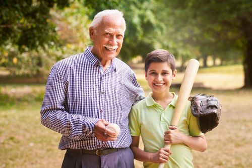 Grandfather and grandson playing baseball