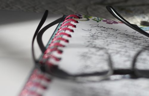 eyeglasses resting on top of a journal