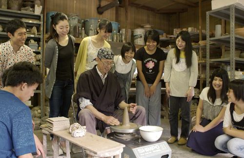 Elder Aoba creating pottery with youth