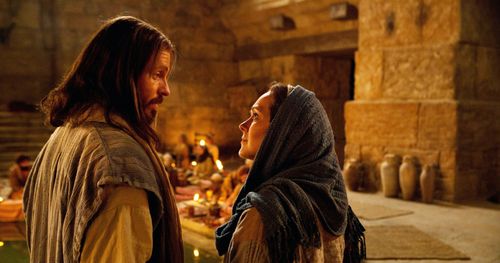 Jesus talking to Mary at a wedding feast.
