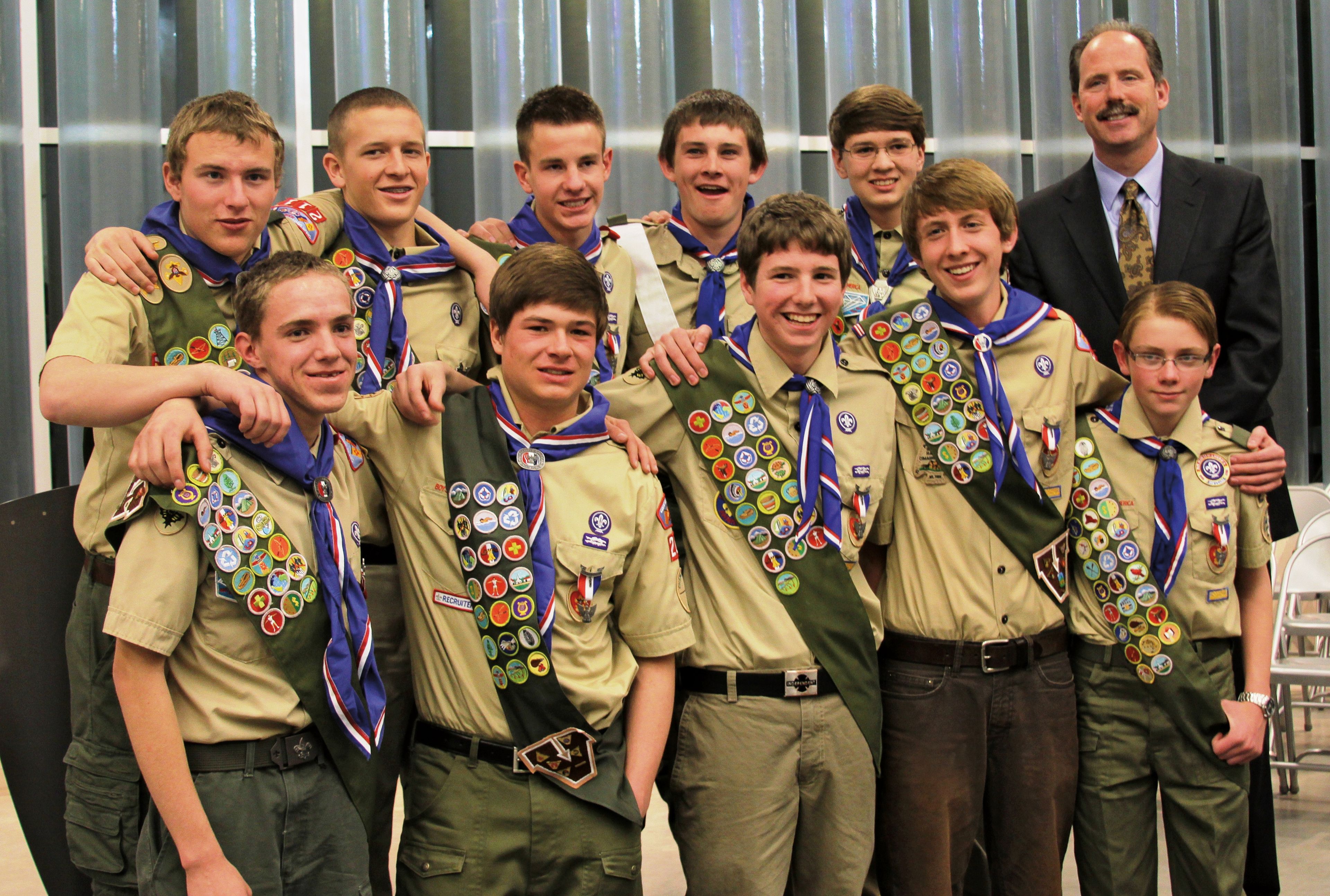 A group of young men stand together for a picture as Boy Scouts.