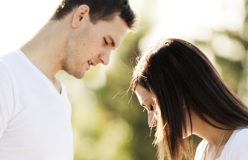 young man speaking to a young woman