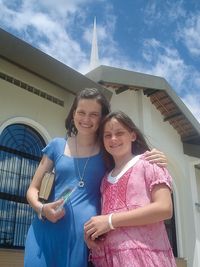 young women in front of meetinghouse