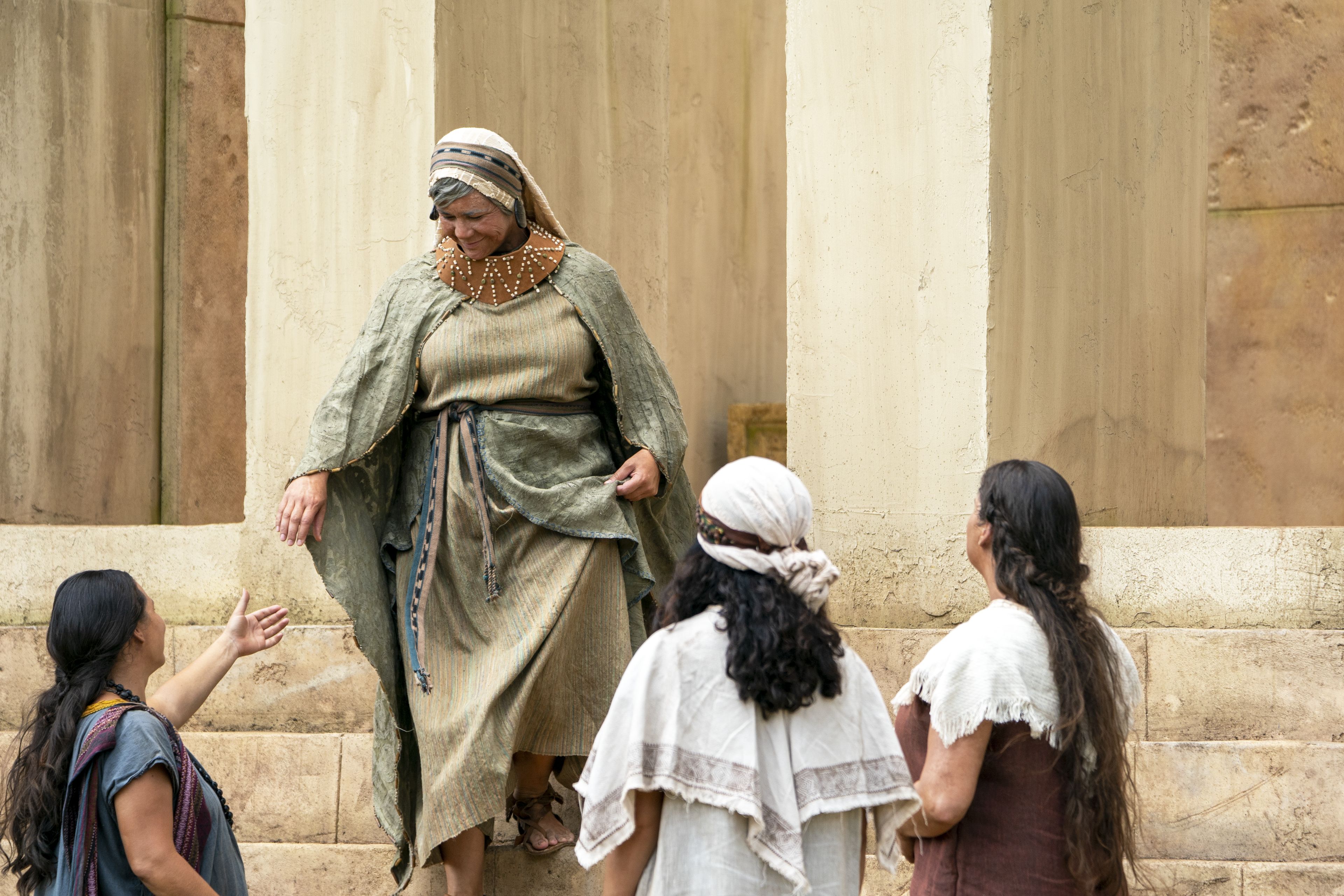 King Benjamin's Wife greets Nephite women as she emerges from the temple in the Land of Zarahemla.