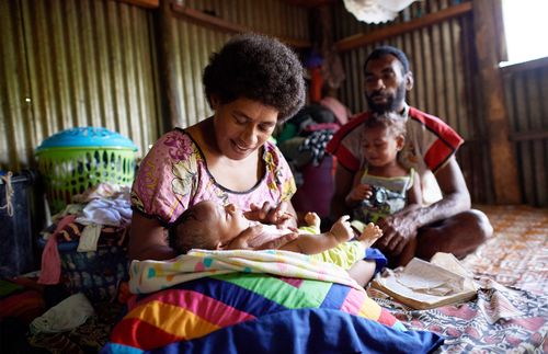 a mother and father with two children