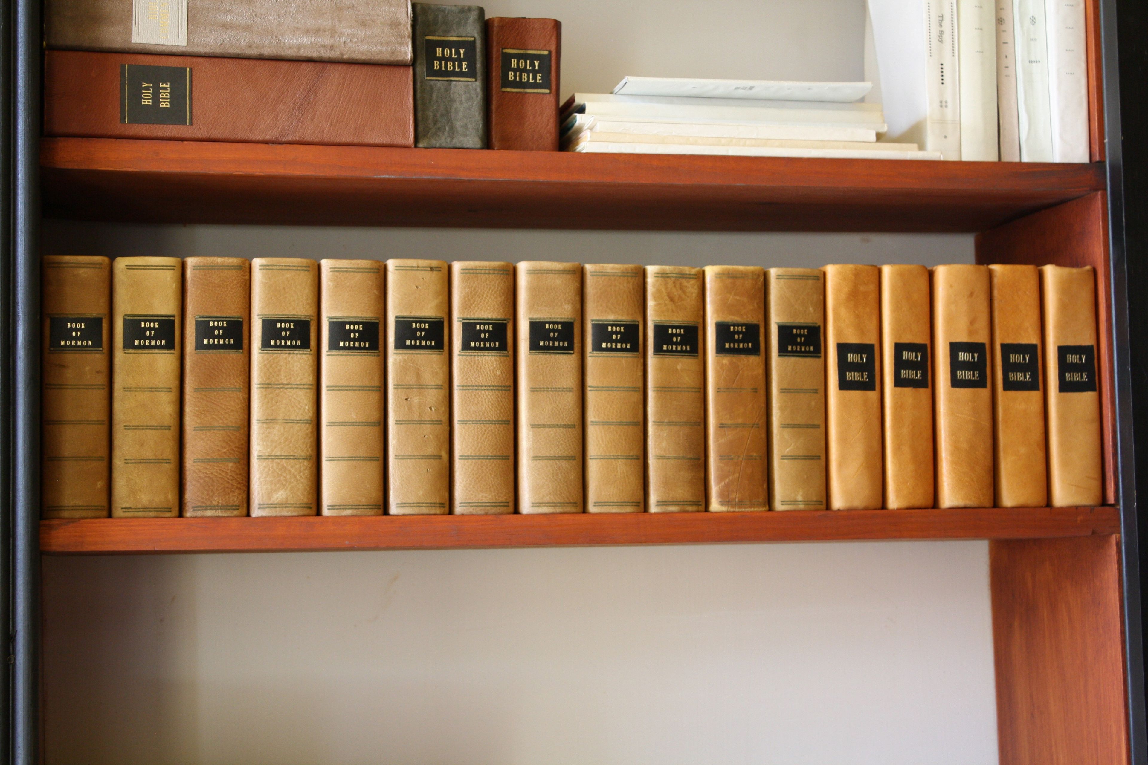 A shelf with copies of the Book of Mormon in the Grandin Print Shop.