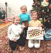 Children holding the pavlova they made