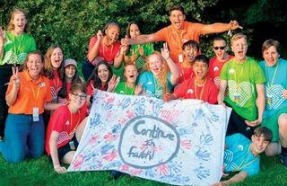 group of young men and young women holding a banner