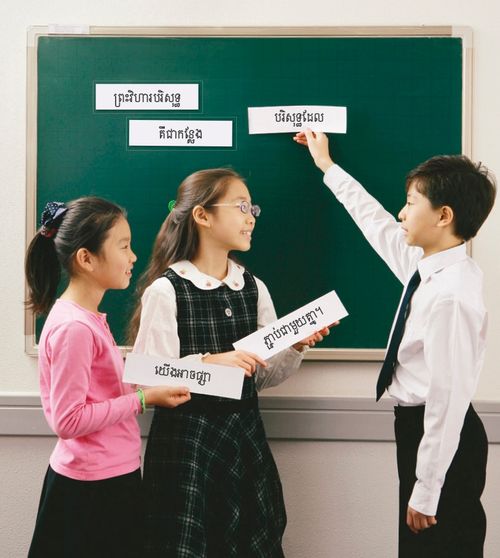 Primary children holding up word strips