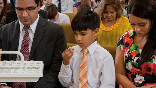 child partaking of the sacrament