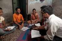 missionaries teaching a family in Mumbai, India