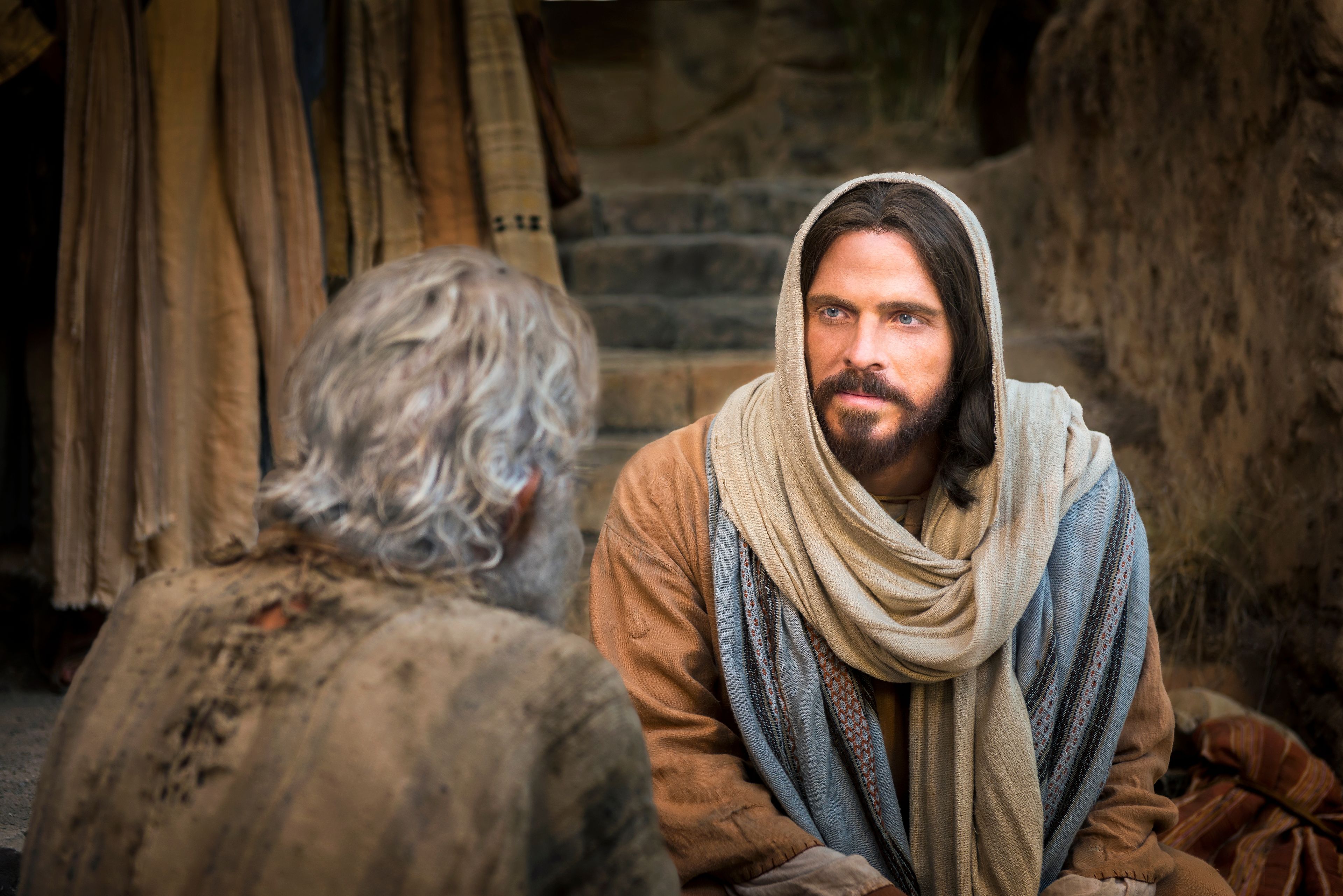 Christ sitting beside a man and healing him.