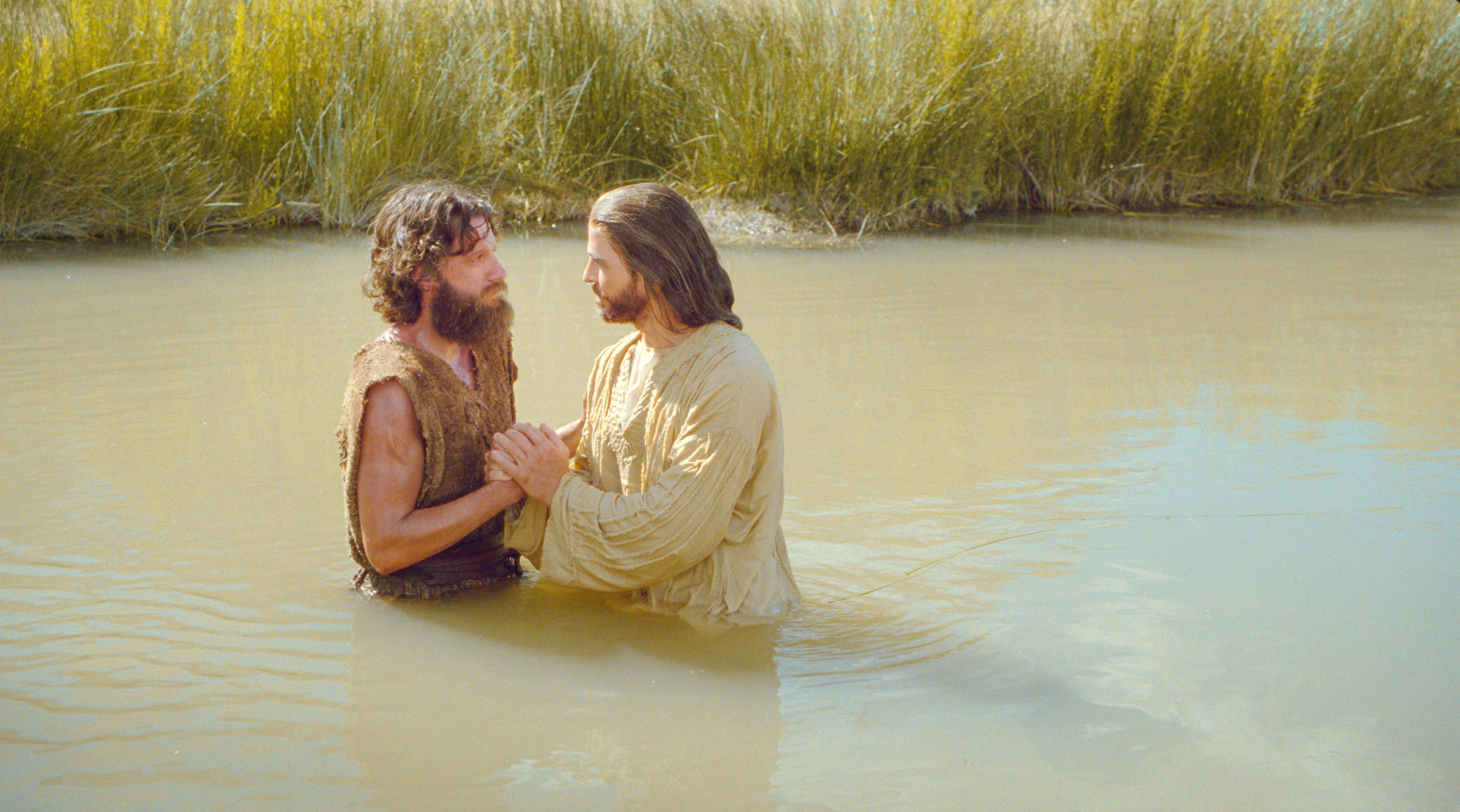 As Jesus enters the water to be baptized, John declares that he must be baptized by Jesus. Jesus responds that He must be baptized to fulfill all righteousness.