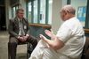 A man, presumably a chaplain or member of a bishopric, sits in the chapel room visiting with an inmate. They appear to be in conversation together.   Special Services of the Priesthood department has requested that PSD capture images of various Correctional facilities that will be used on websites and curriculum targeted to spiritually support LDS members in correctional confinement and their families.