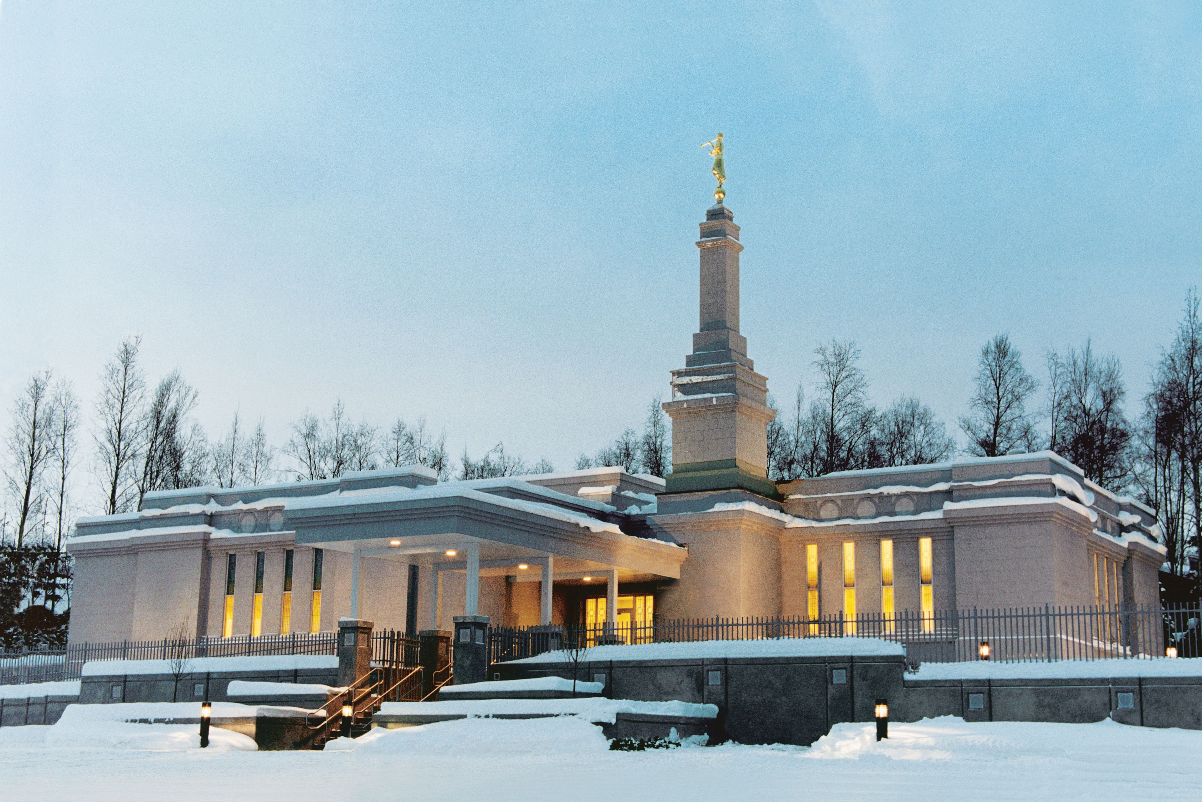 An exterior view of the entrance of the Anchorage Alaska Temple in the evening.